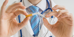doctor breaking a cigarette in half